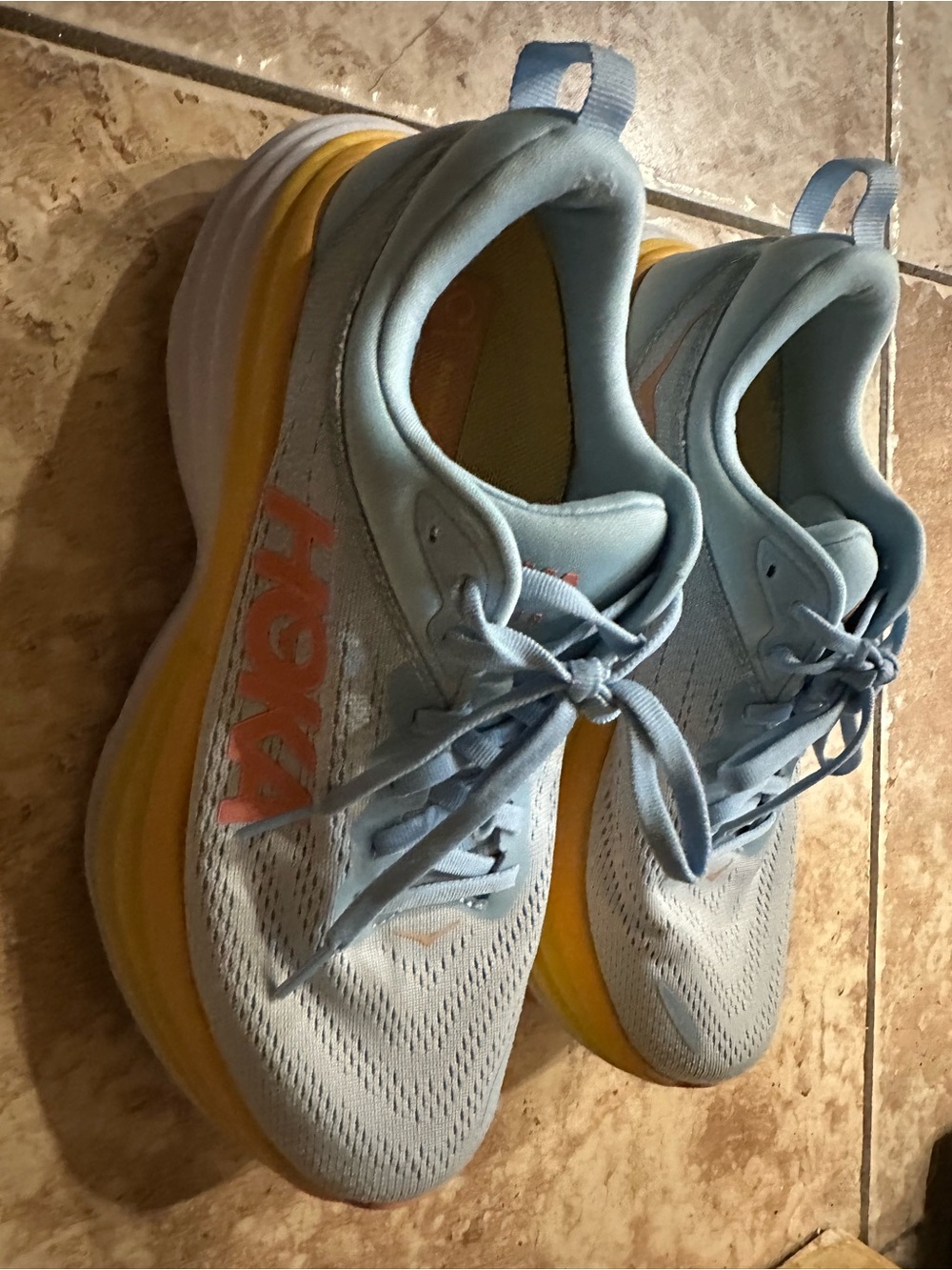 Hoka One One light blue and yellow running shoe